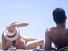 Topless putting on lotion